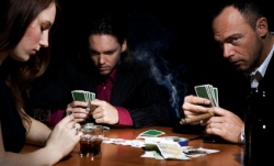 two men and one woman, poker game, money on the table, cigar smoke